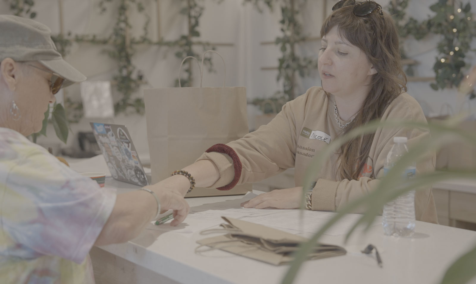 Nicole Redler, of Re-Compass, hands out a compliant cannabis donation at Root'd in the 510 Dispensary in Oakland at a Happy Management event.