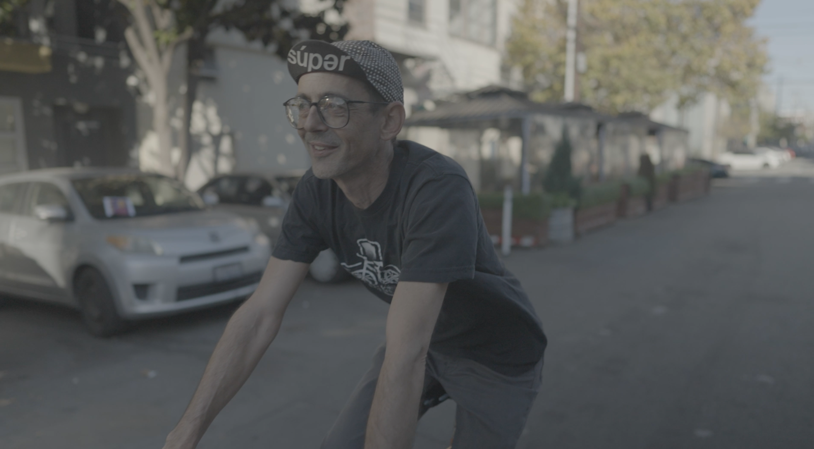 Sweetleaf Joe rides a bike down the street in San Francisco.